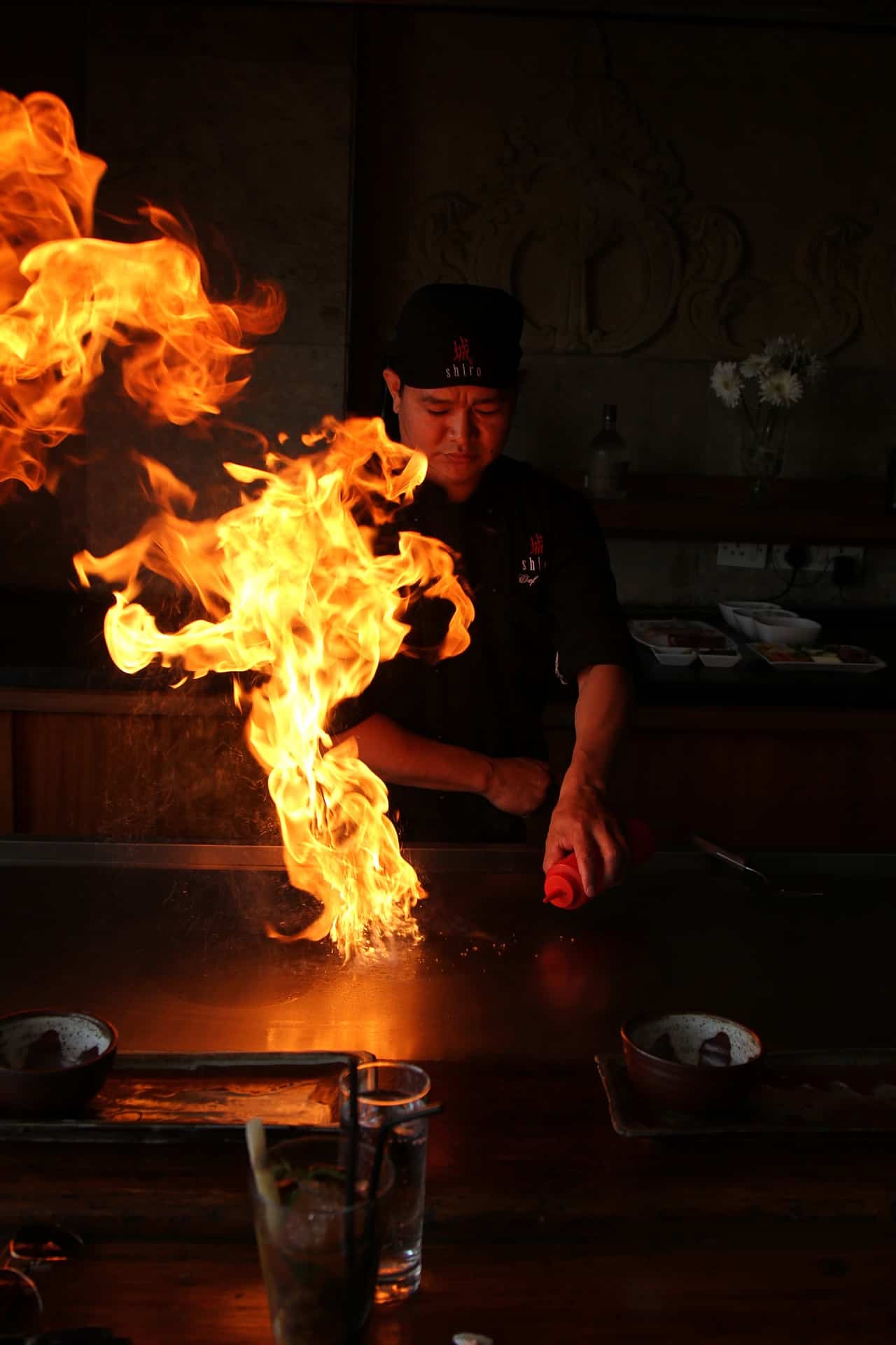 a chef is doing one of teppanyaki tricks, Onion Volcano.