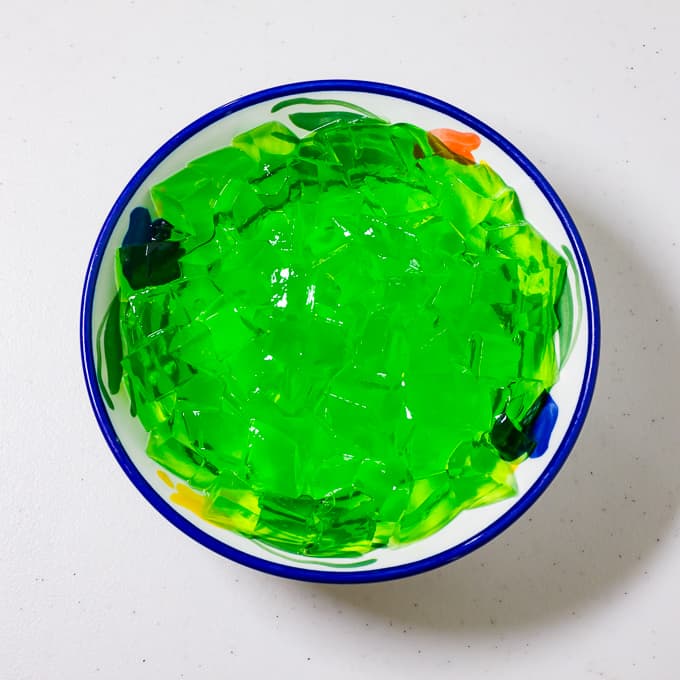 Cubed green gelatin in a bowl