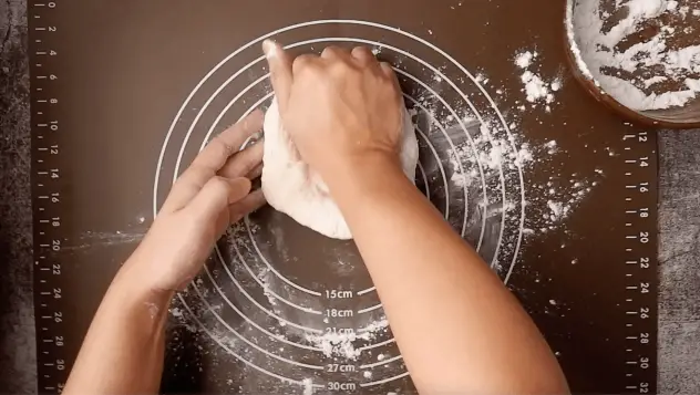 Kneeding dough on a flat surface