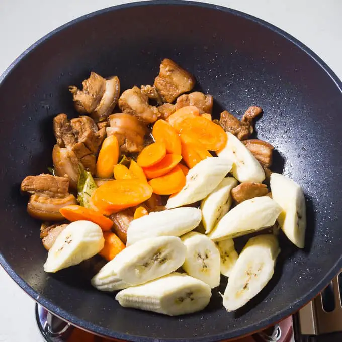 Liempo Estofado pork belly ingredients in a wok