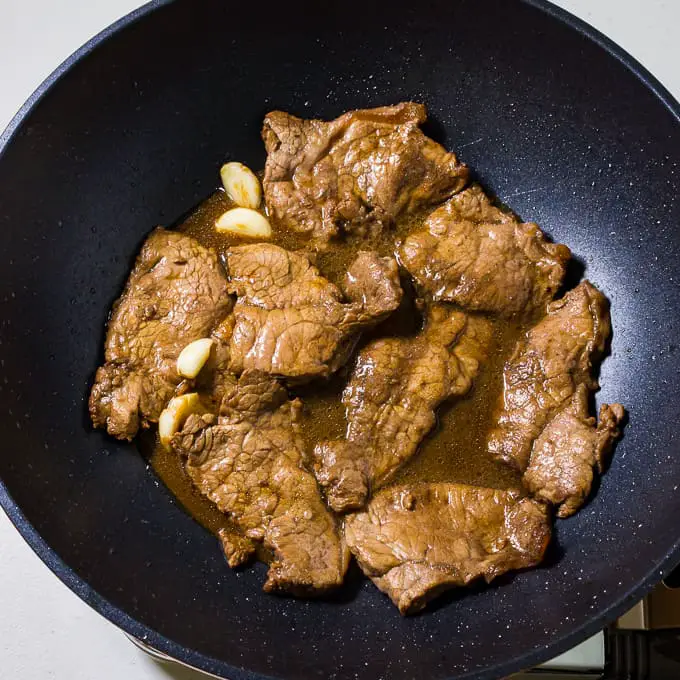 Marinated beef simmering with garlic