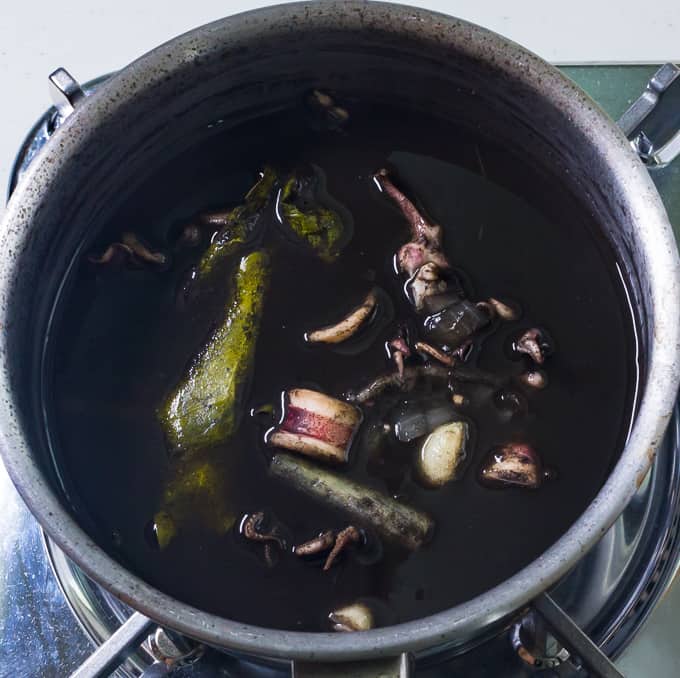 Squid in its own ink in a cooking pot