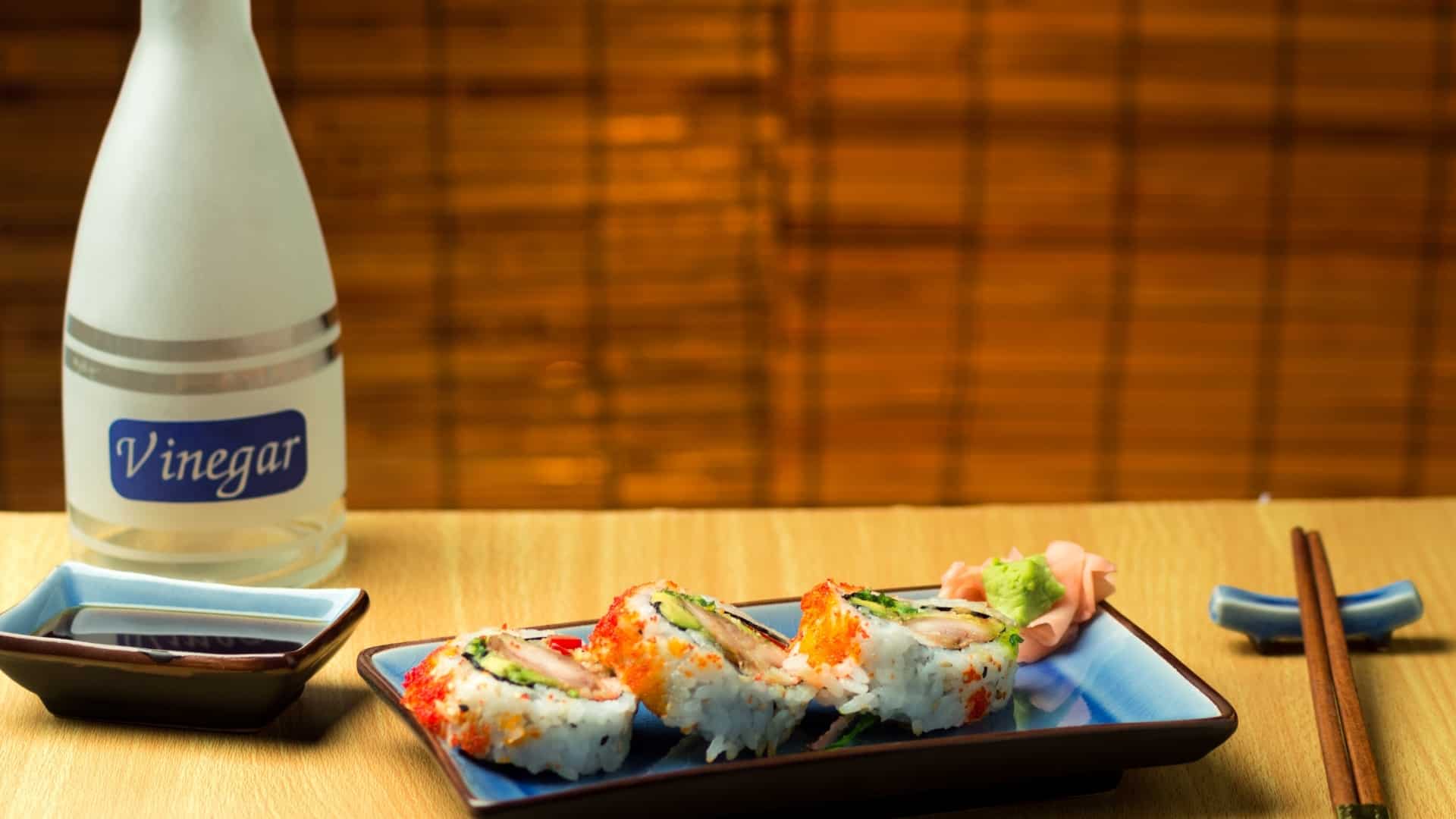 Japanese sushi vinegar on a table with pieces of sushi