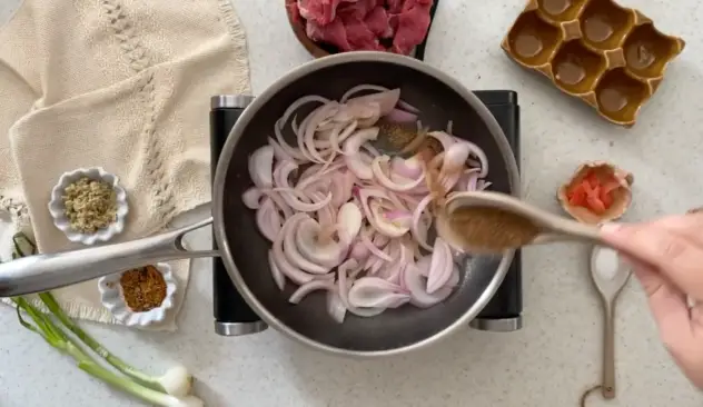 Gyudon adding seasonings to sauteed onions