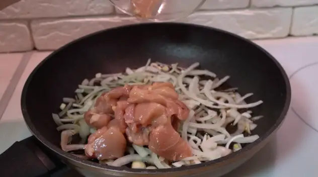 親子丼のフライパンに鶏肉を入れる