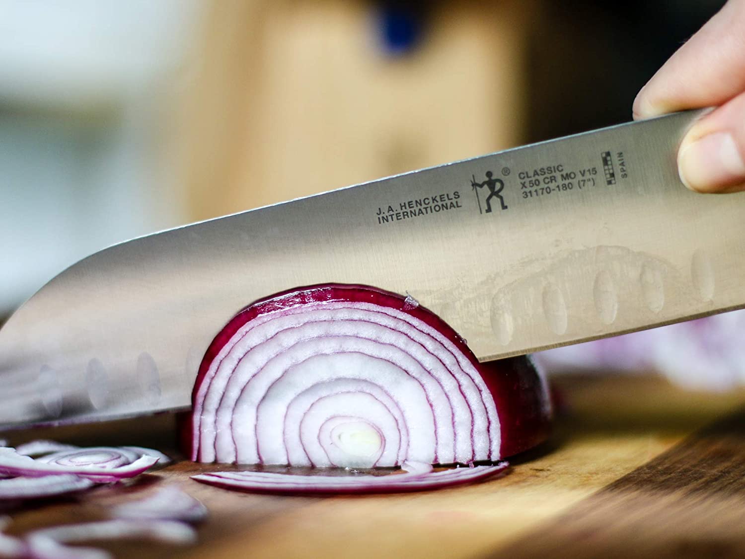 Best mid-priced santoku knife- J.A. HENCKELS Classic Hollow Edge in use