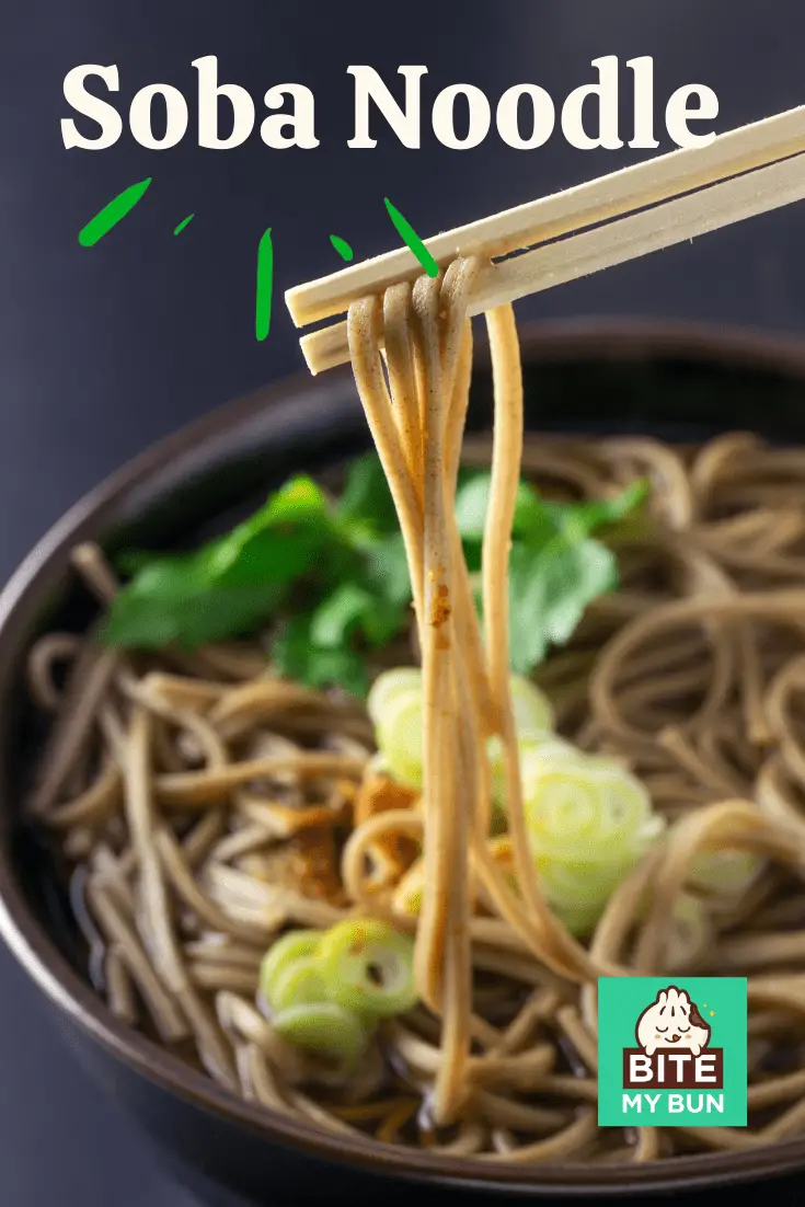 chopsticks holding up soba noodles against bowl
