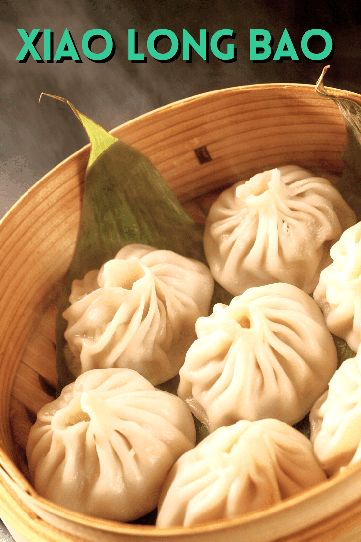 an open bamboo steamer with xiao long bao