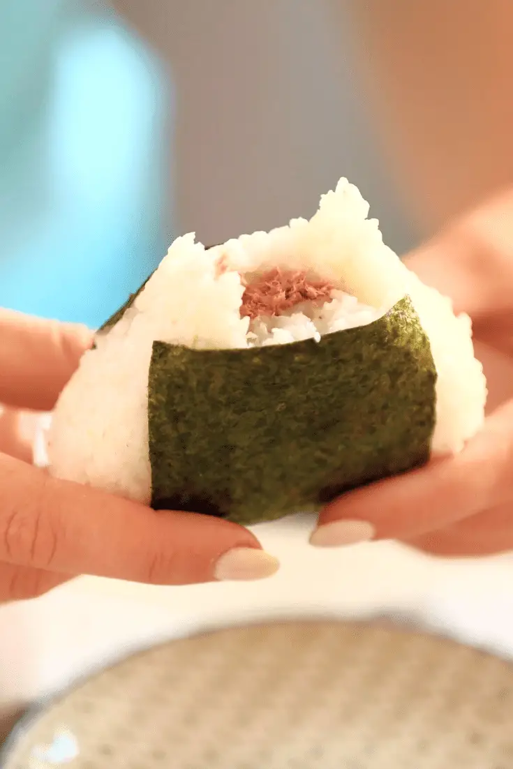 closeup of omusubi with a bite off the top