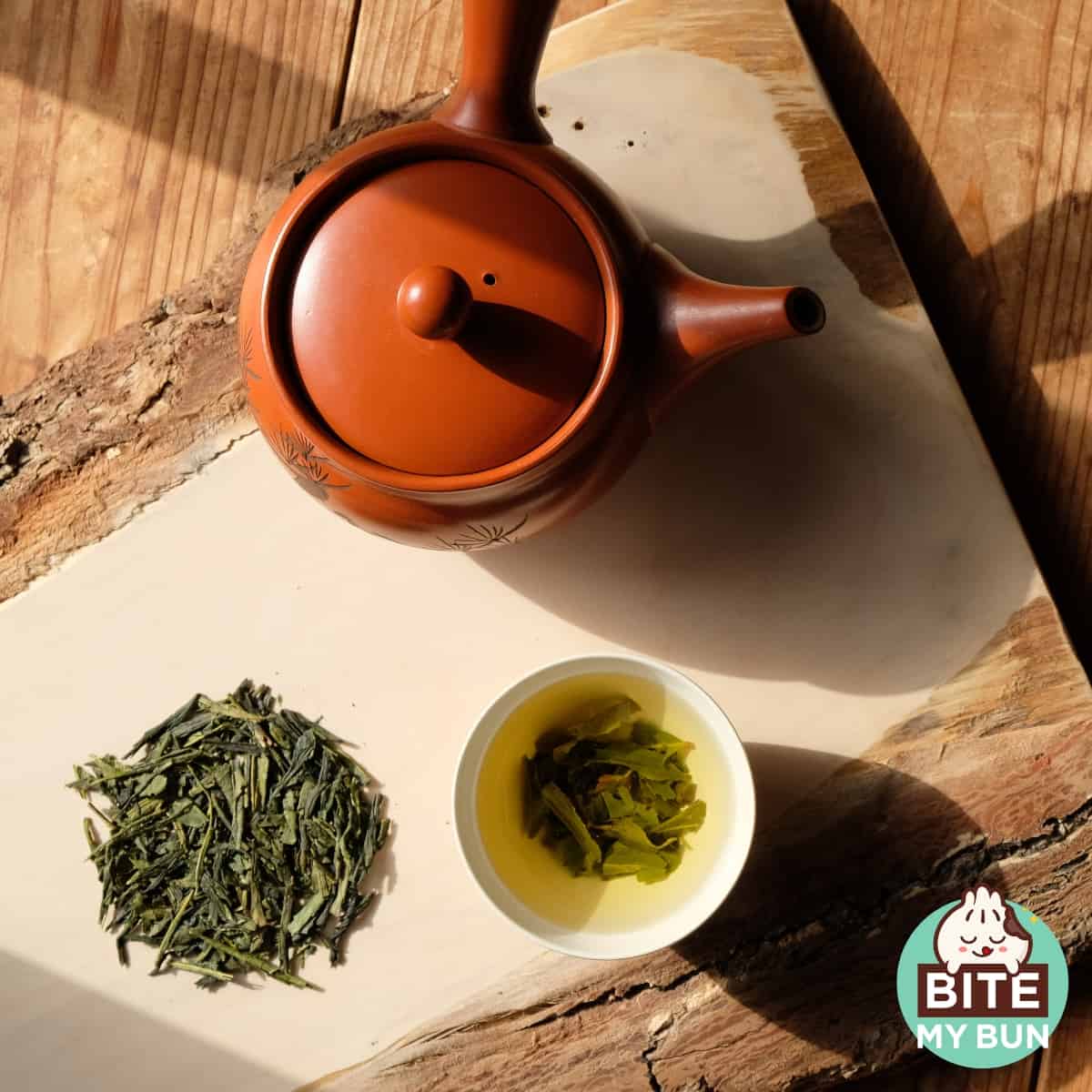 Cup of Bancha tea and leaves on a table